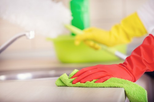 Local technician treating sofa stains with upholstery equipment